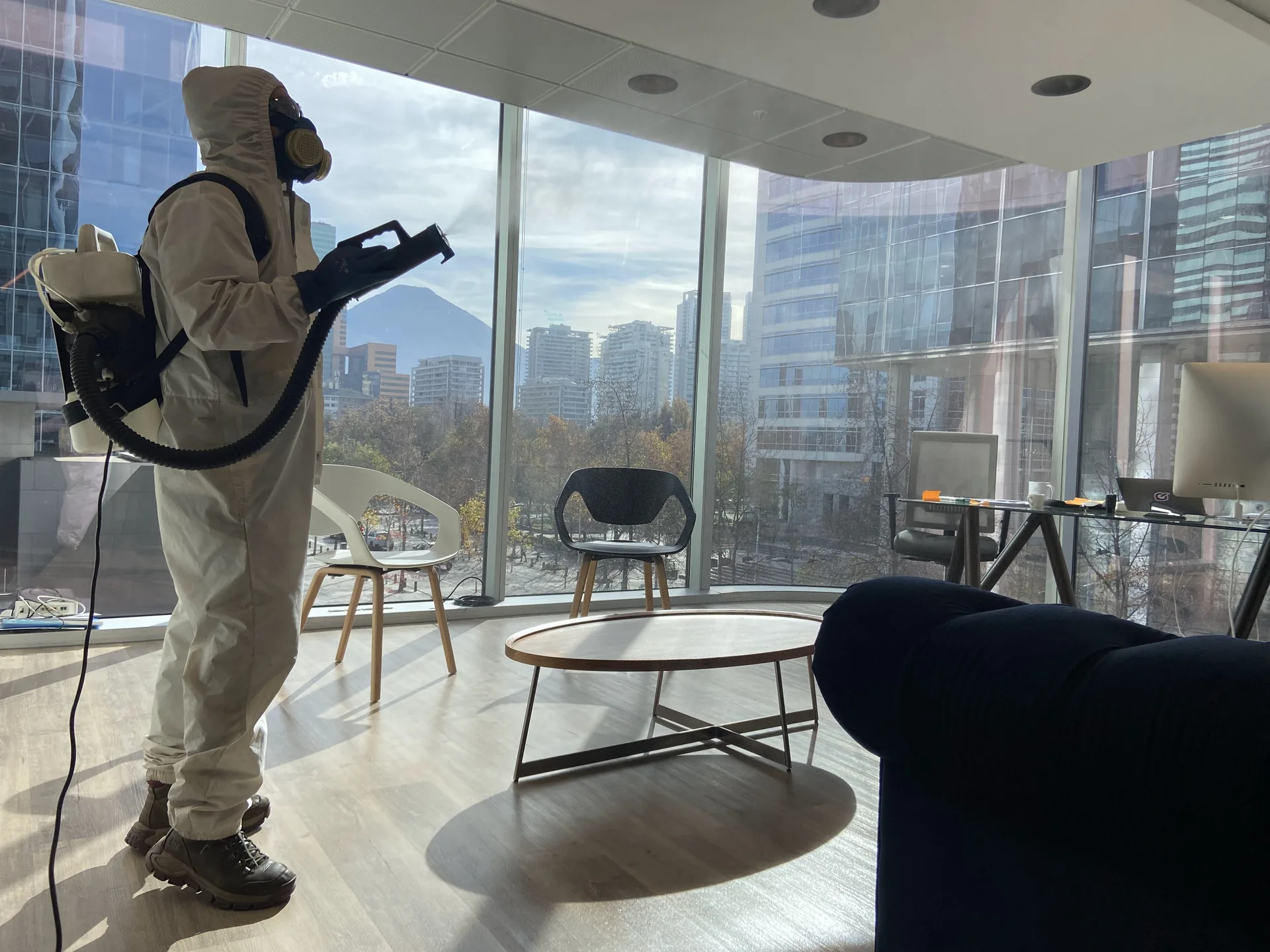 CTRLPLAGAS technician wearing protective coveralls, respirator, gloves and safety footwear